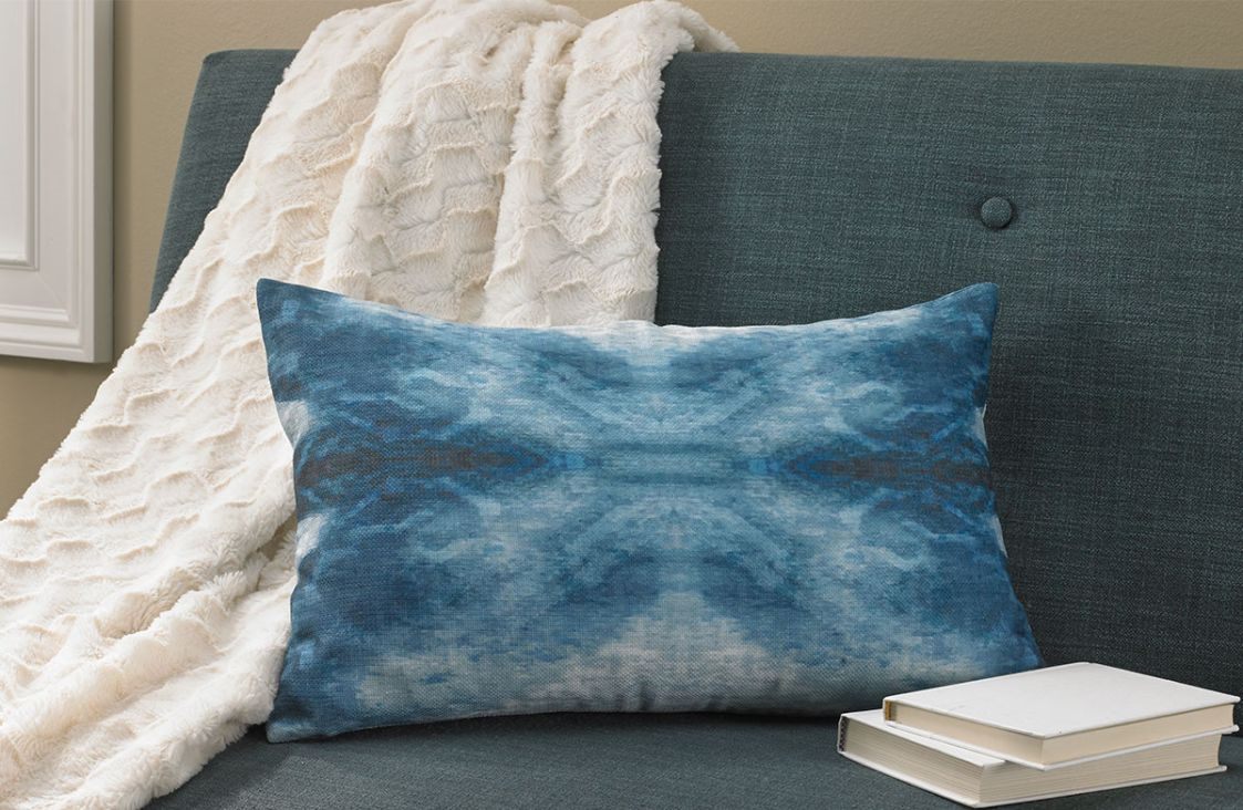 Decorative cushion in blue dip-dye pattern